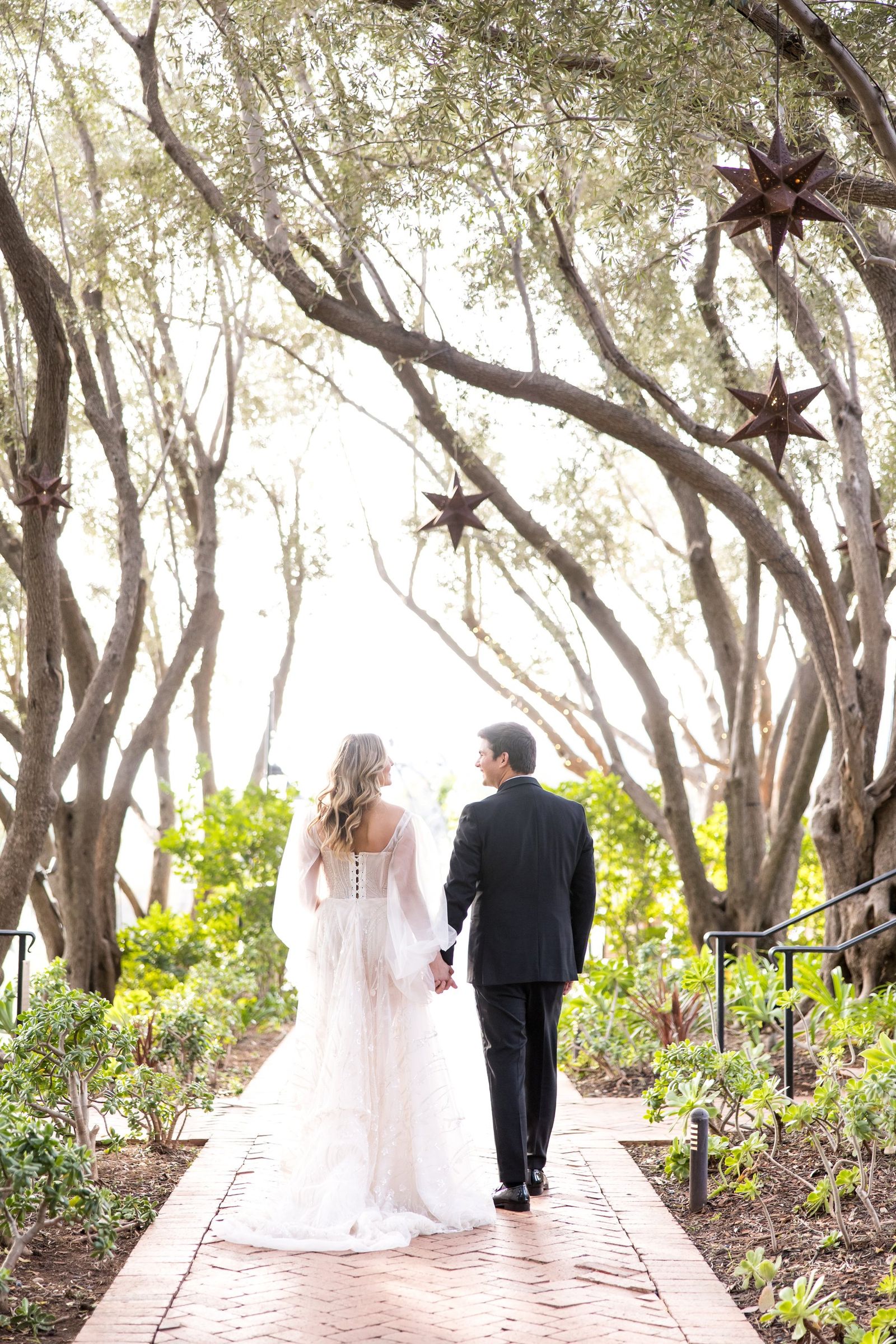 Couple walking through oak canopy